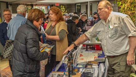 RPV Emergency Preparedness Committee member at table sharing informative materials with attendees