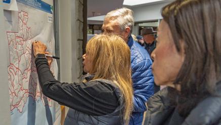 Attendees interacting with emergency zones map