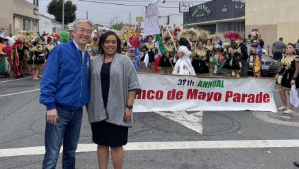 Asm. Muratsuchi and Mayor Cerda in front of parade participants and banner