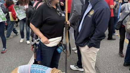Asm. Muratsuchi speaking with attendee with dog