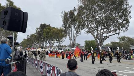 Marching band and flag team taking part in parade