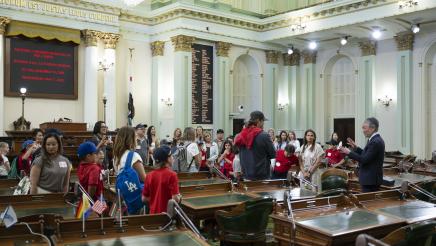 Asm. Muratsuchi on the Assembly Floor speaking to students, teachers and parents