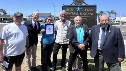 Asm. Muratsuchi and attendees in front of Blue Star Memorial Highway sign