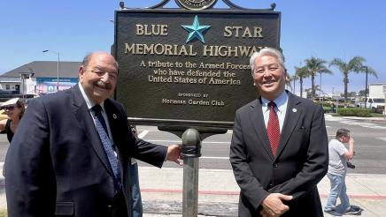Asm. Muratsuchi and attendee in front of Blue Star Memorial Highway sign